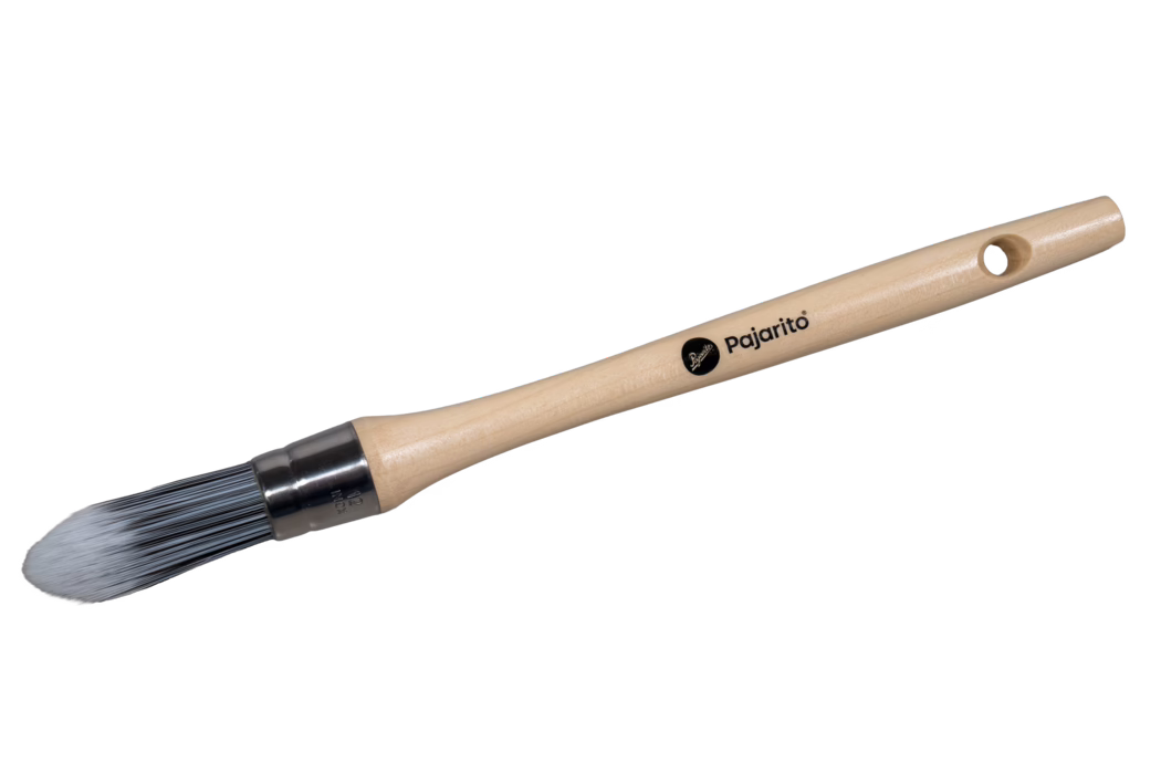 Ein rundspitziger Malpinsel mit langem, glattem Griff aus hellem Holz und einer runden Metallzwinge, die nach oben zulaufende graue Synthetikborsten hält. Auf dem Griff ist das schwarze 'Pajarito'-Logo aufgedruckt und nahe dem Ende befindet sich ein Aufhängeloch. Der Pinsel ist auf weißem Hintergrund fotografiert und zeigt seine schlanke, zugespitzte Form.